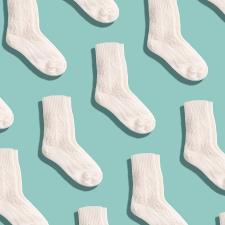 Pattern of white socks on a teal background