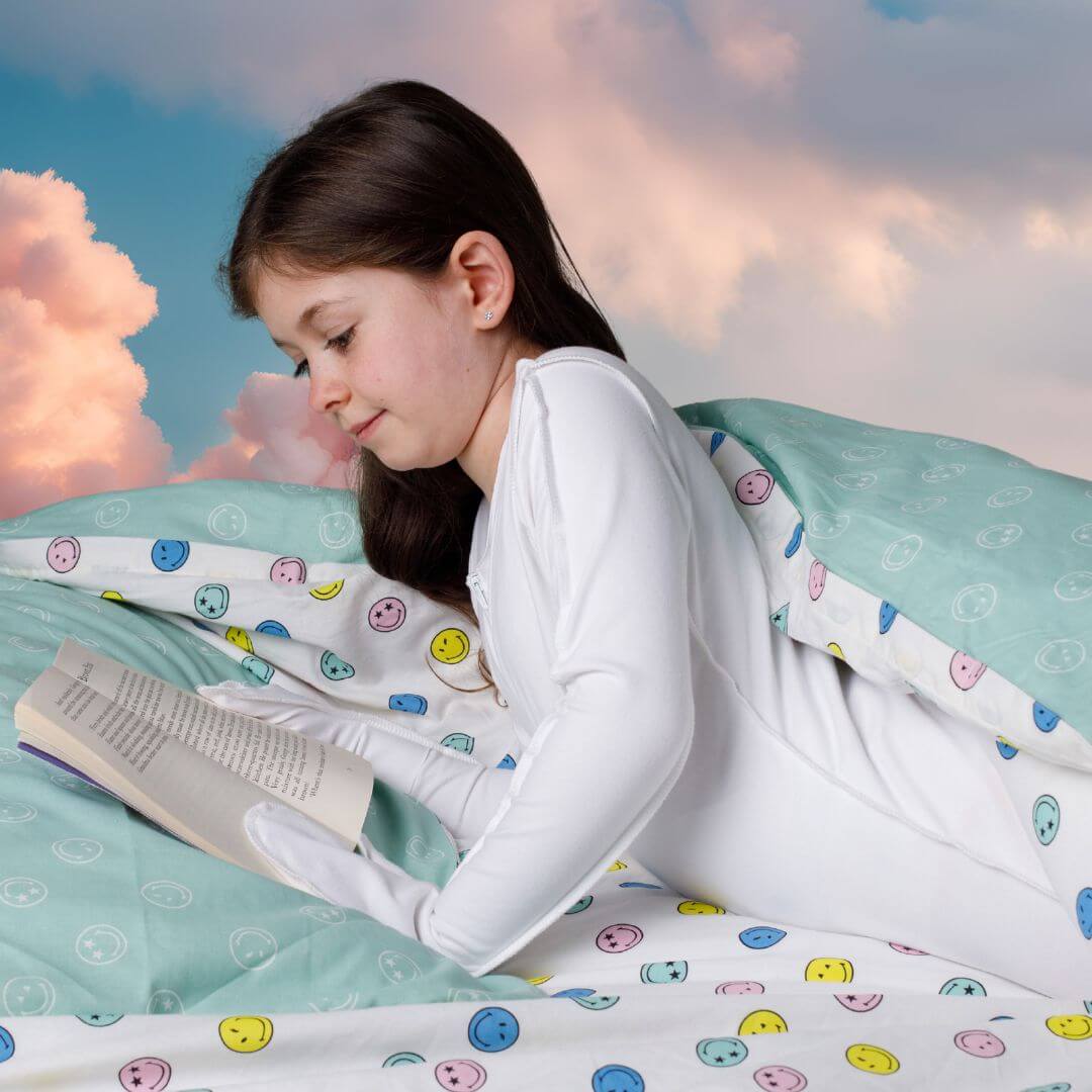 Girl reading a book, wearing a skinakin sensitive skin body suit