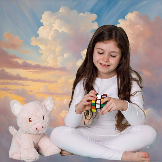 A girl playing happily with a Rubix Cube, wearing a Skinakin Eczema Clothing Dermasuit.  Background of blue sky and pink fluffy clouds.  She has a pink toy pig beside her.