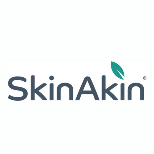 Skinakin eczema clothing logo.  Grey font with a green leaf above the letter 'i'.