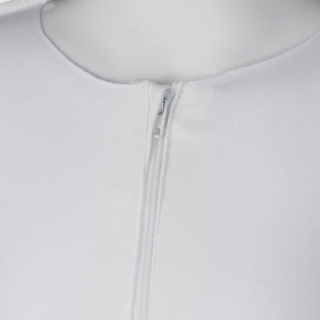 A close up of Skinakin's white eczema suit zip front feature, which allows easy dressing and comfort.