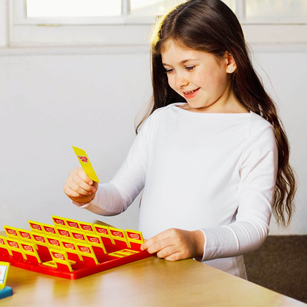 Young girl playing with a educational game on a table